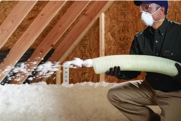 worker using a blower insulation