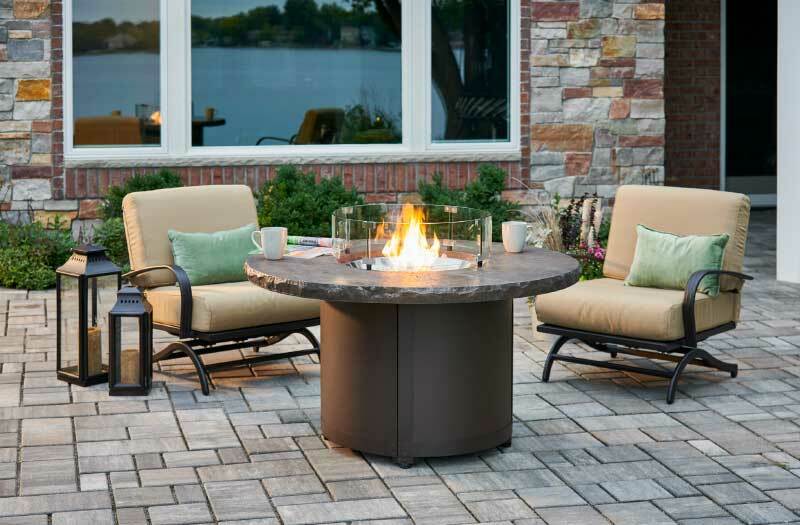 Cylindrical outdoor fireplace with round tabletop.