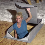 Woman entering an attic through a zippered access cover.