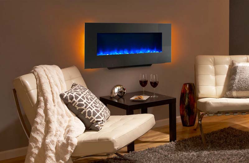 Wall-mounted electric fireplace with blue flame in a modern lounge setting with two chairs and a table.