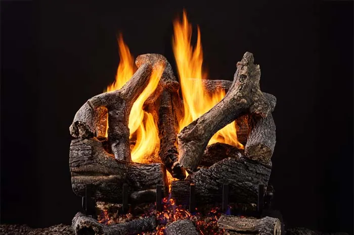 Grand Oak 3-Tier Remote Control Gas Log Set with hand-painted oak logs, glowing embers, and tall flames against a black background.