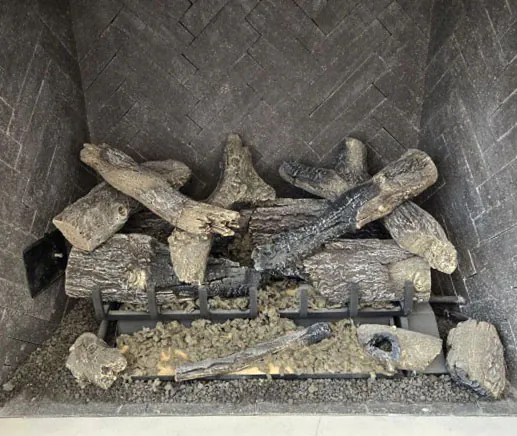 Grand Oak 2-Tier 30-inch remote control gas log set Grand Oak 2-Tier 30-inch remote control gas log set shown unlit with full two-tier log arrangement on grate inside herringbone-tiled fireplace.