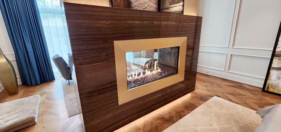 Before: Stellar 4-foot see-through gas fireplace ready for service. Stellar 4-foot see-through linear gas fireplace (model 4-ST-2-GL) before service by Perfection Supply in Houston, TX, showing the unlit firebox and stone media behind the glass.